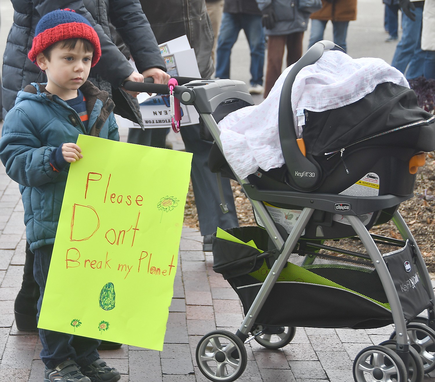 A boy carries a sign, “Please don’t break my planet.” © 2017 Karen Rubin/news-photos-features.com